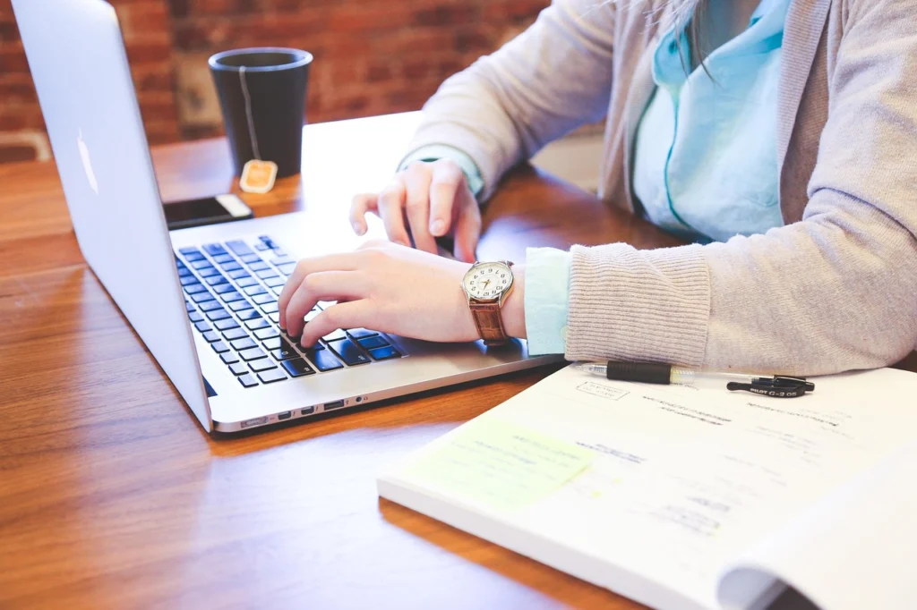 person typing optimized content on laptop