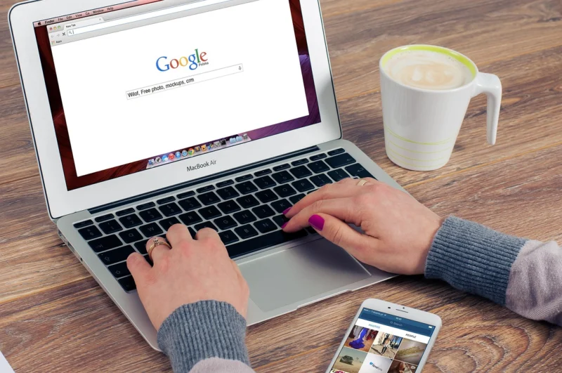 Laptop with coffee and notebook for SEO analysis planning